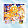 Toile et strass de diamond painting montrant un grand bonhomme de pain d'épices dans un village de Noël avec stylet et plateau.